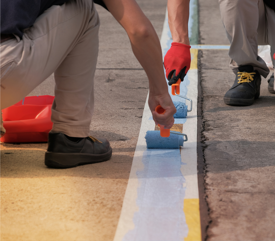 Painting road lines with blue roller