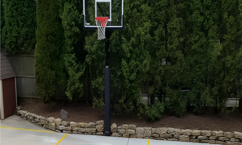 Backyard basketball hoop with stone wall