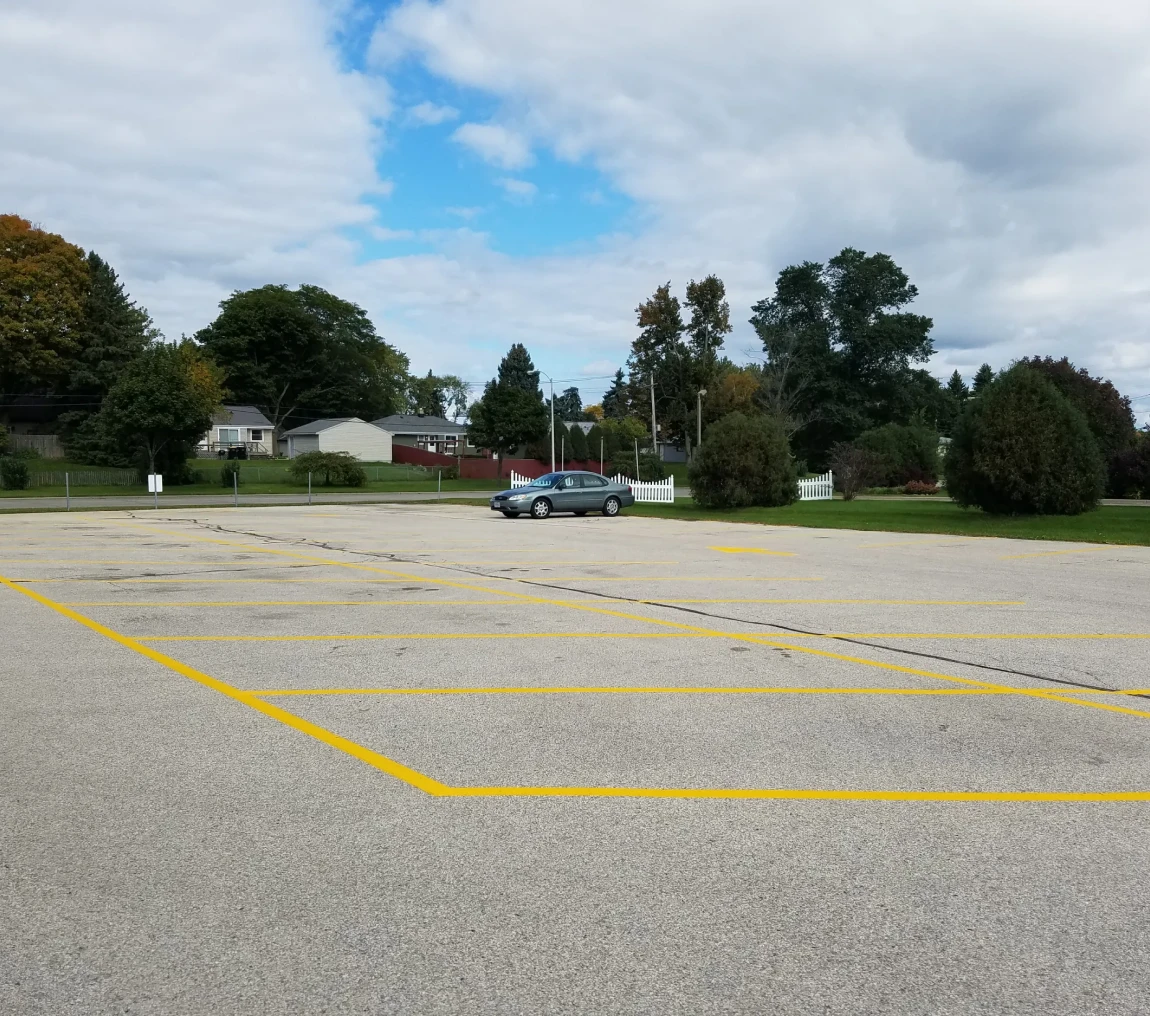 Spacious parking lot under cloudy sky