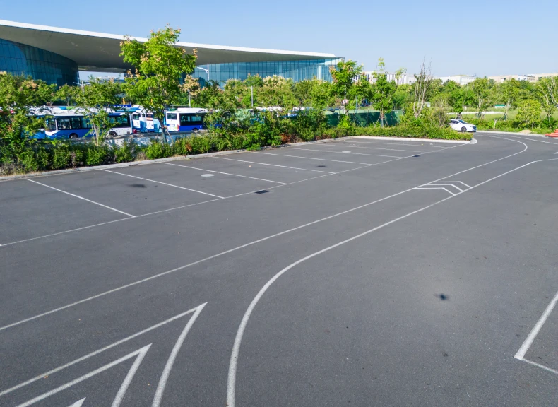 Modern building near asphalt parking area